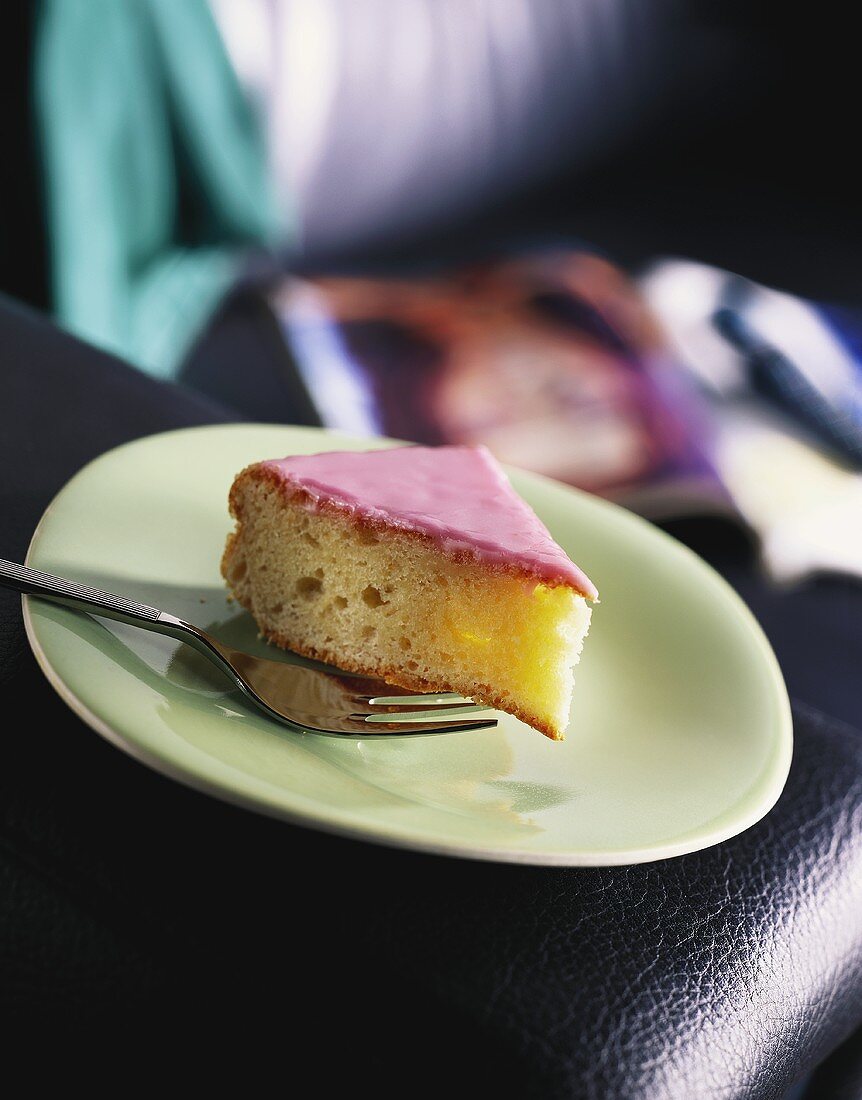 A piece of cake with pink glacé icing