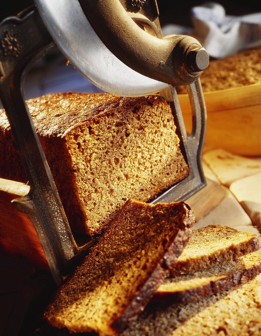 Slicing wholemeal bread with old bread slicer