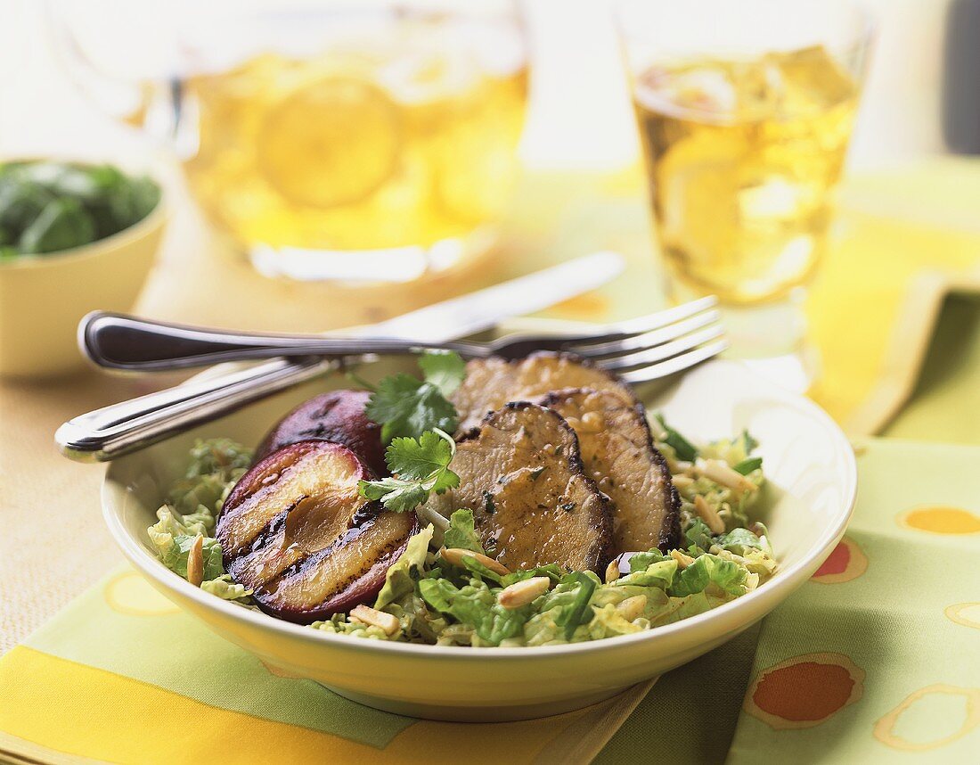 Grilled pork with prunes and salad