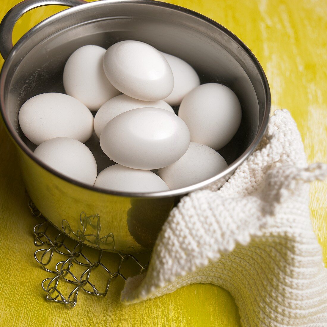 White hen's eggs in a pan of water