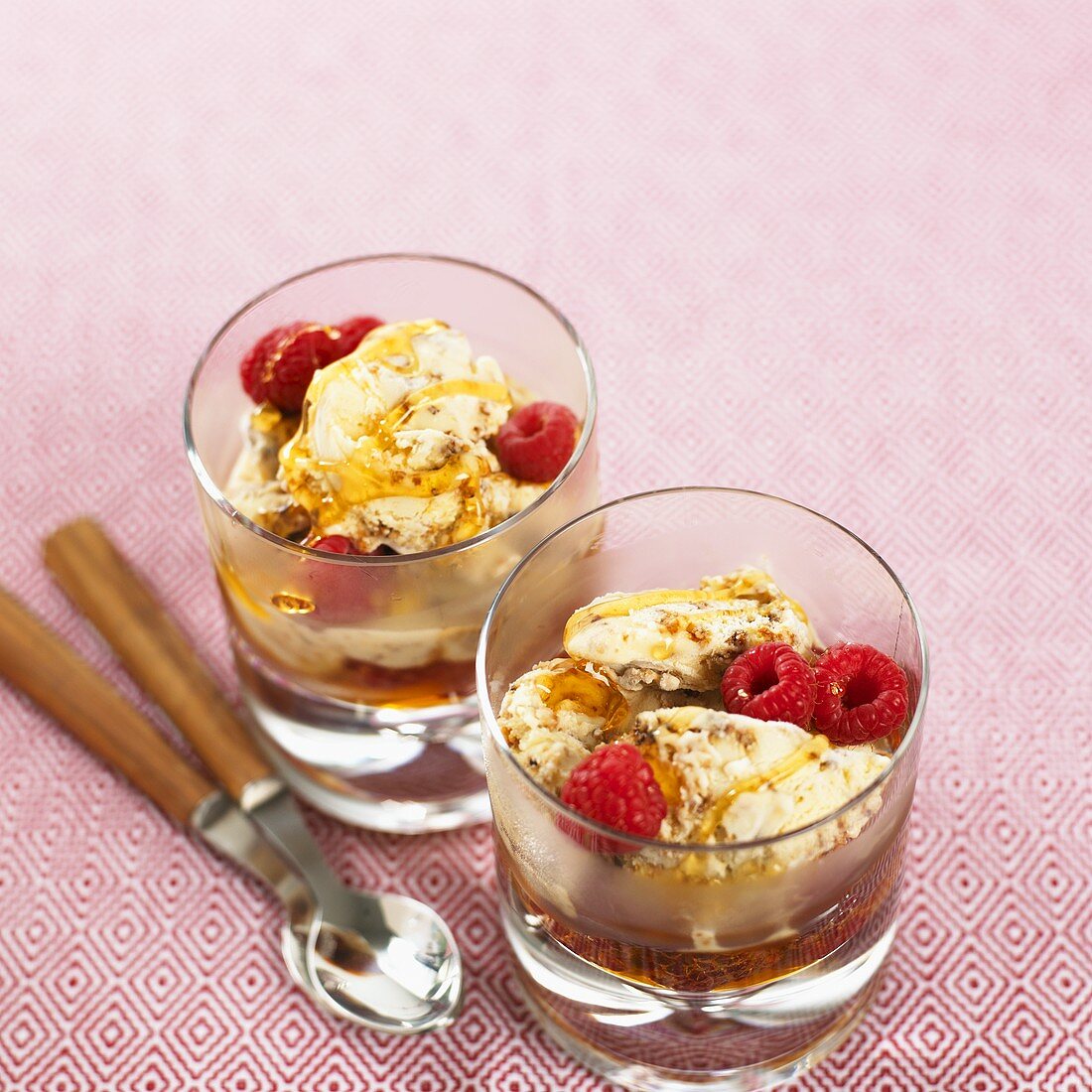 Honey and whisky ice cream with raspberries in whisky glass