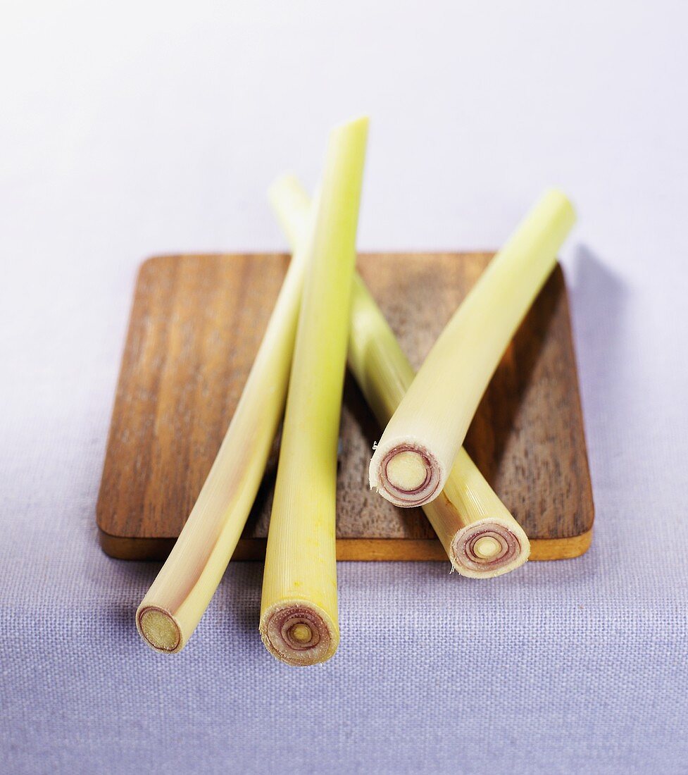 Fresh lemon grass stalks on a kitchen board