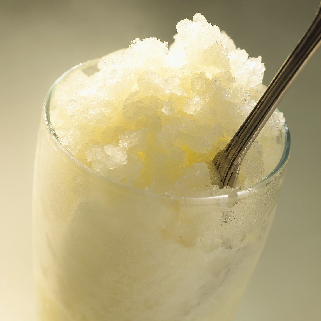 Champagne granita with a spoon in a glass