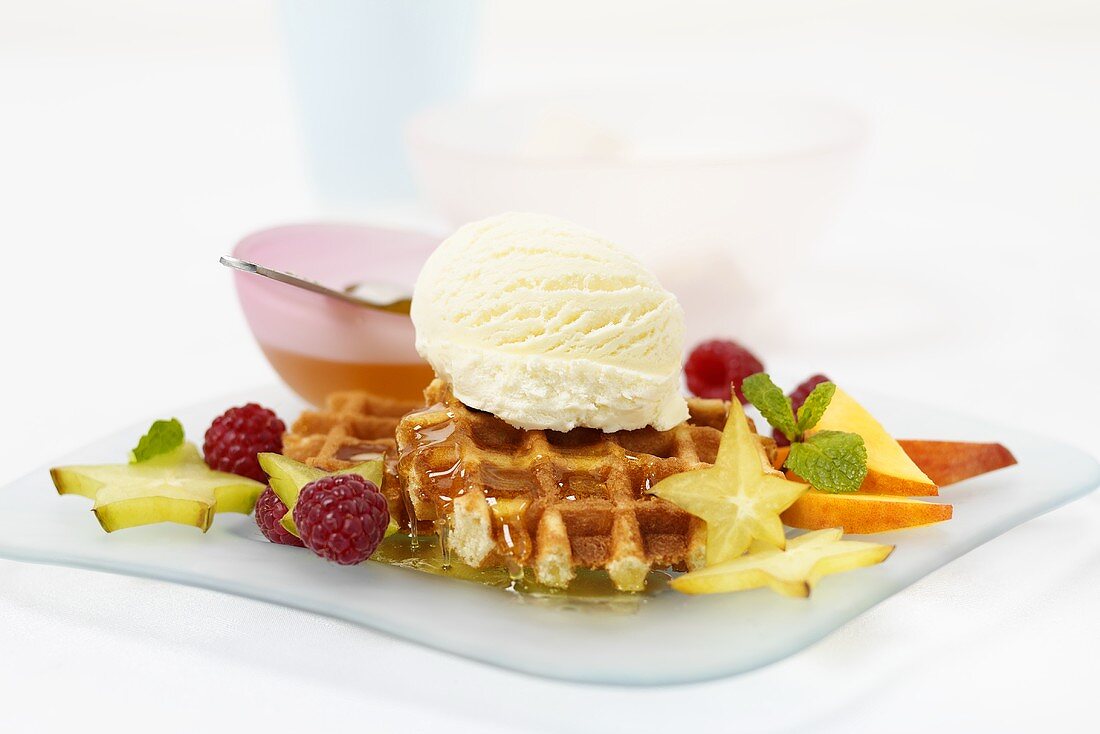 Waffles with honey, fruit and vanilla ice cream