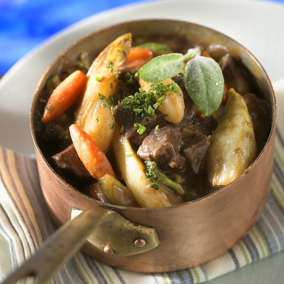 Vegetable stew with meat in copper pan