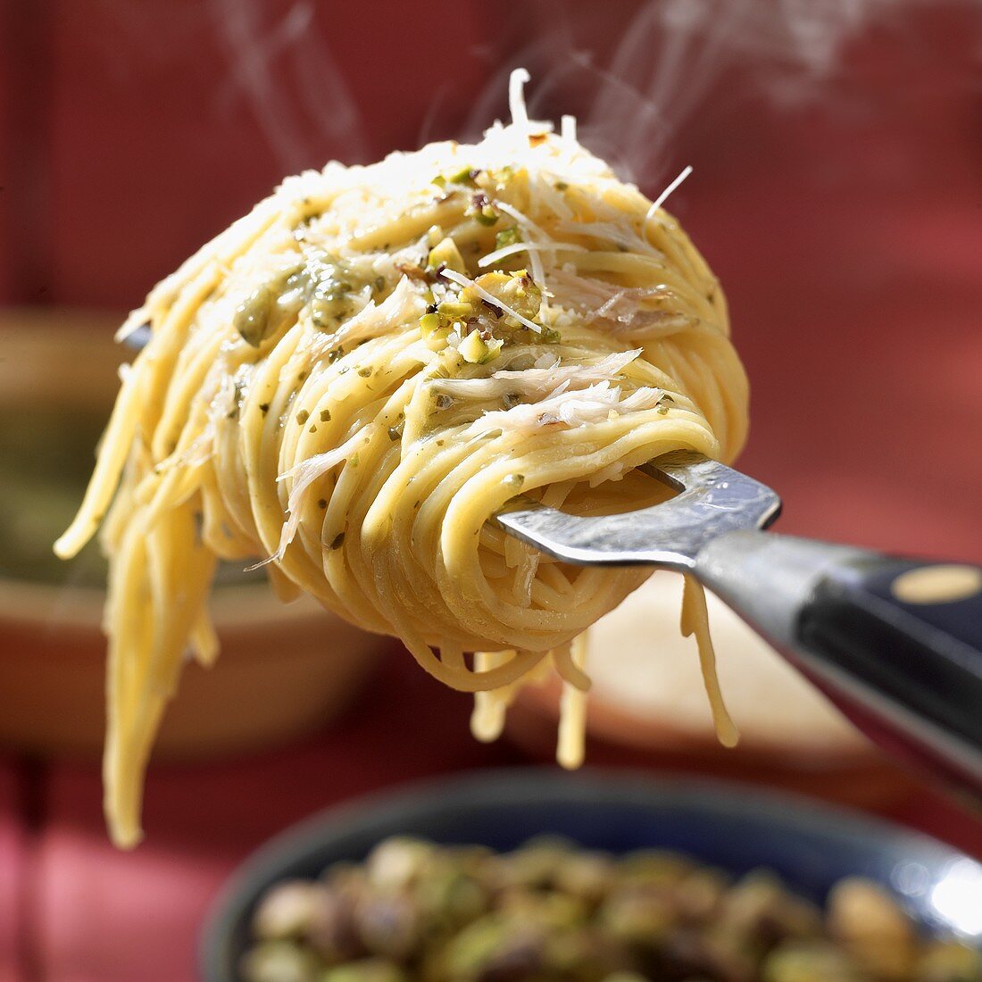 Steaming linguine with pesto wrapped round a fork