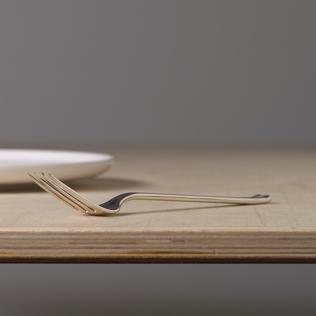 Silver fork on a wooden board