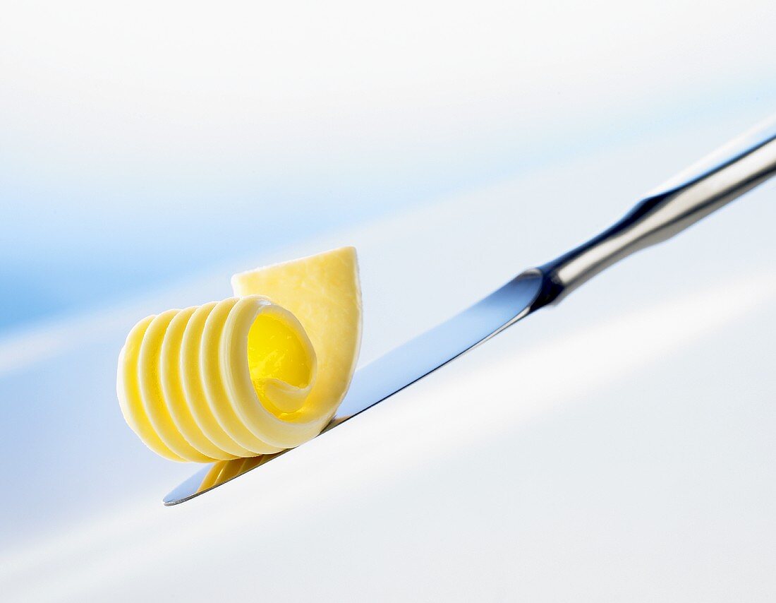 Butter curl lying on back of a knife