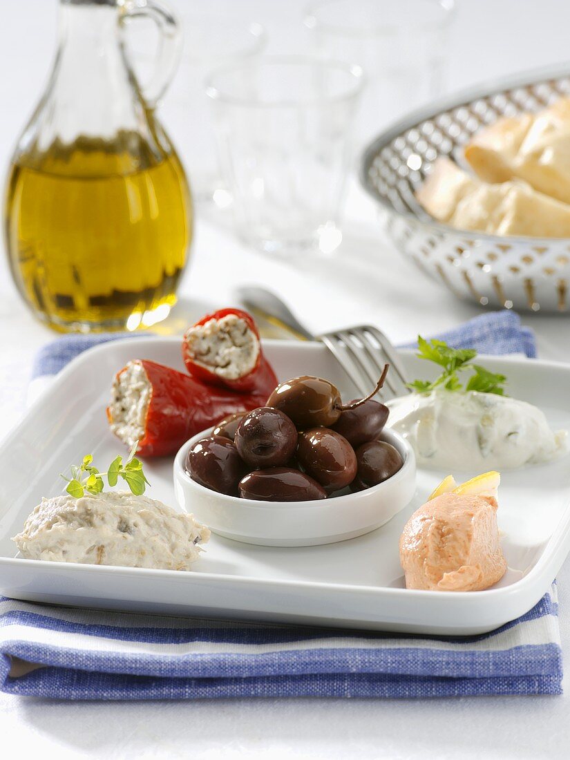 Various crèmes, stuffed chili peppers and olives