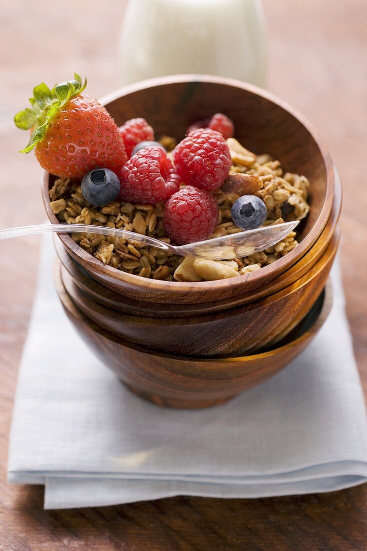 Muesli and berries in wooden bowl