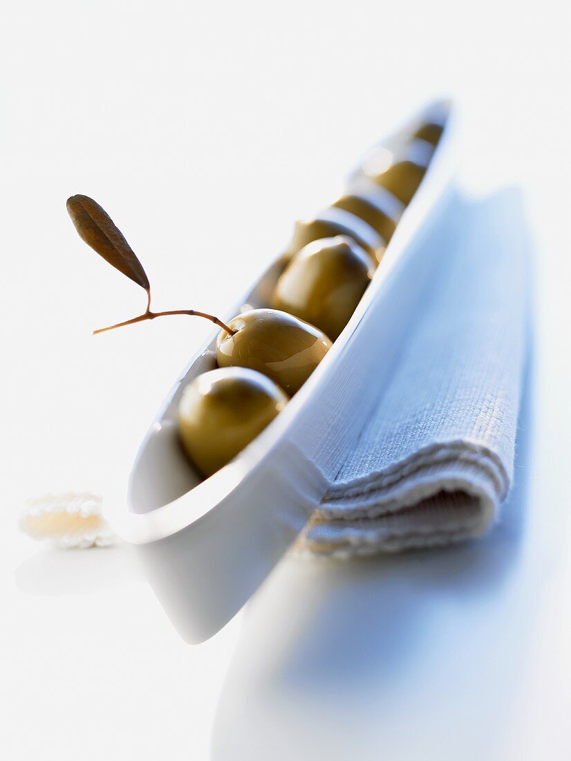 Green olives in an olive boat
