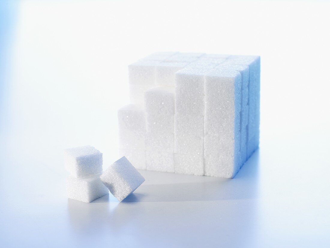 Sugar cubes, partly piled up in a block