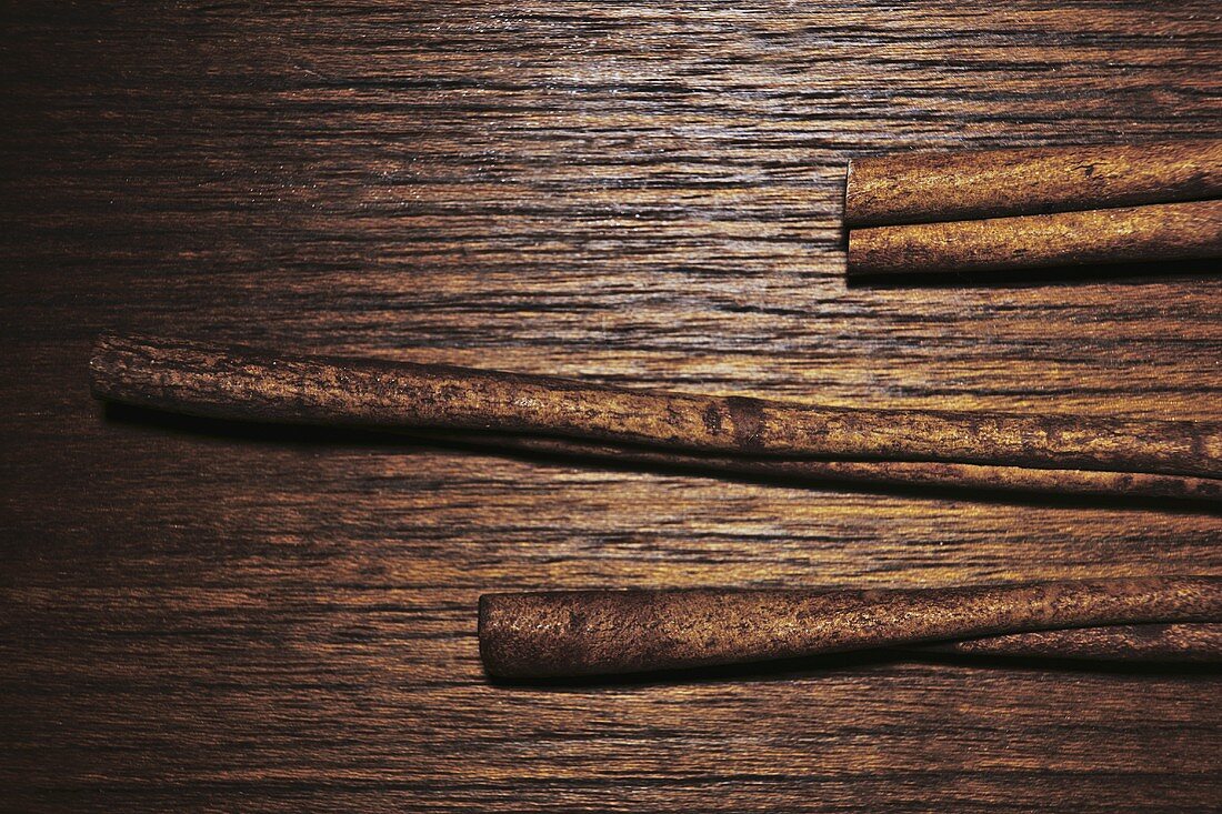 Cinnamon sticks on wooden background