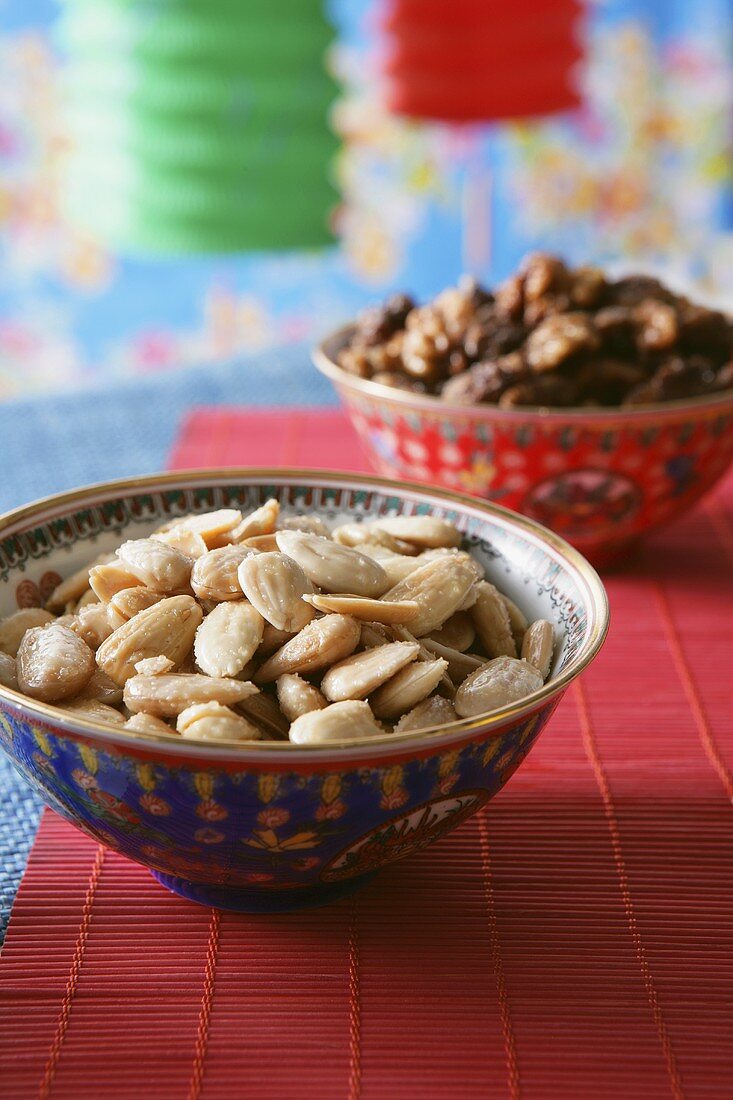 Small bowl of almonds, party decorations behind