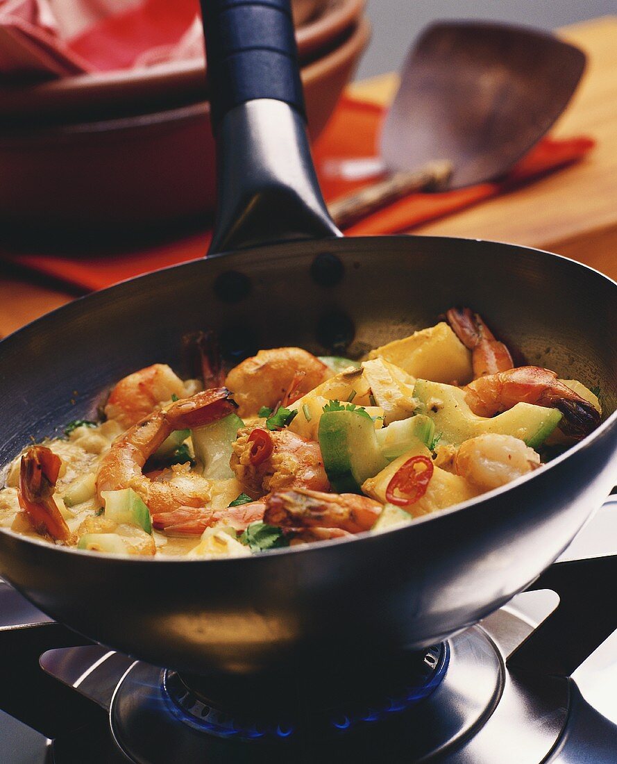 Shrimps with vegetables in a frying pan