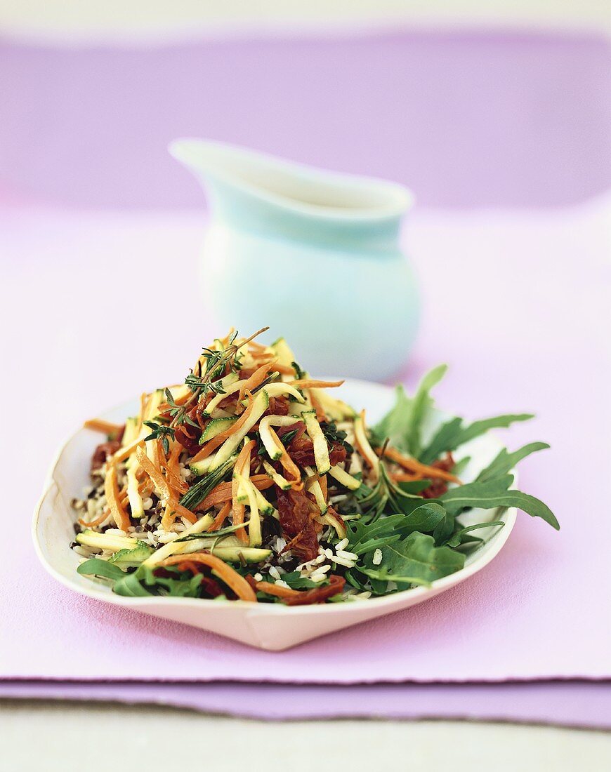 Rice salad with fried vegetables and rocket
