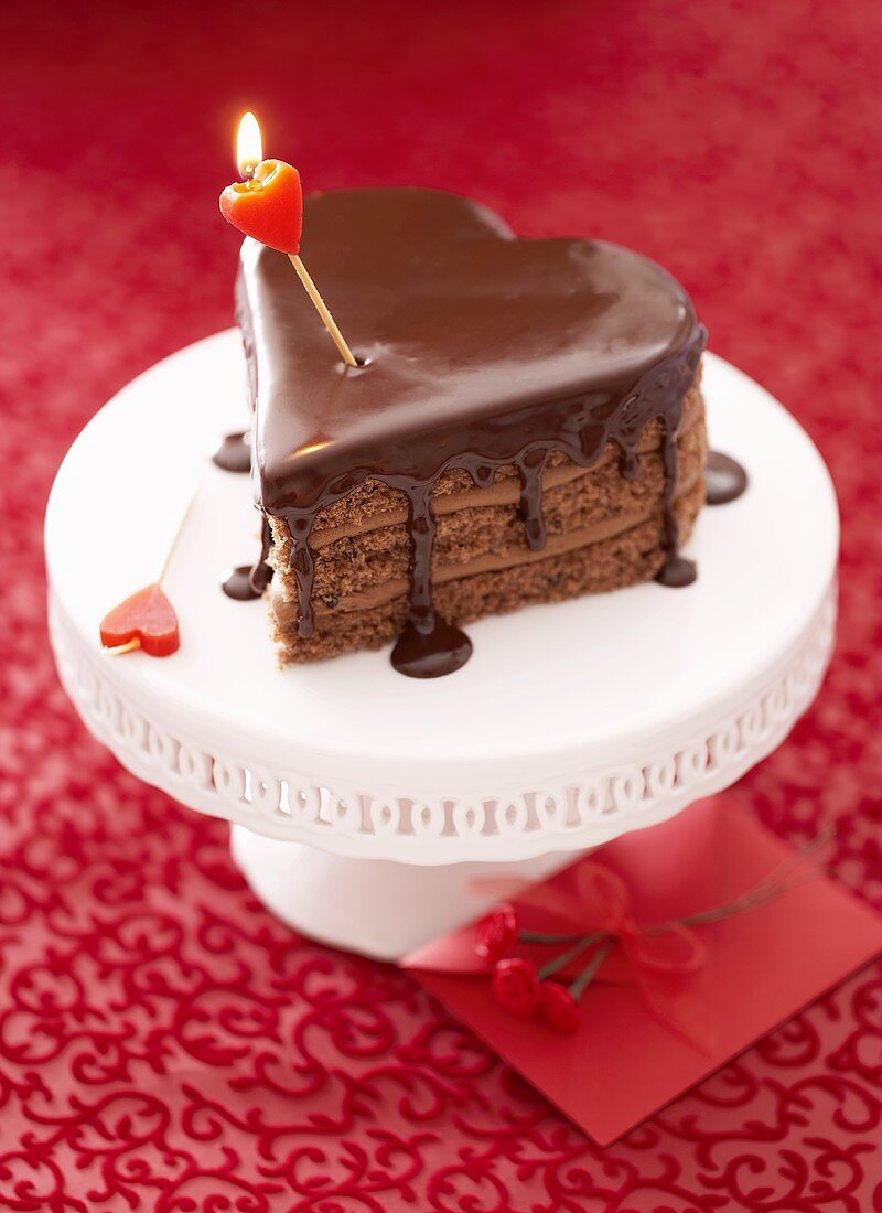 Heart-shaped chocolate cake with candle