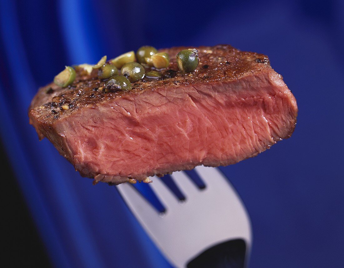 Peppered steak on fork