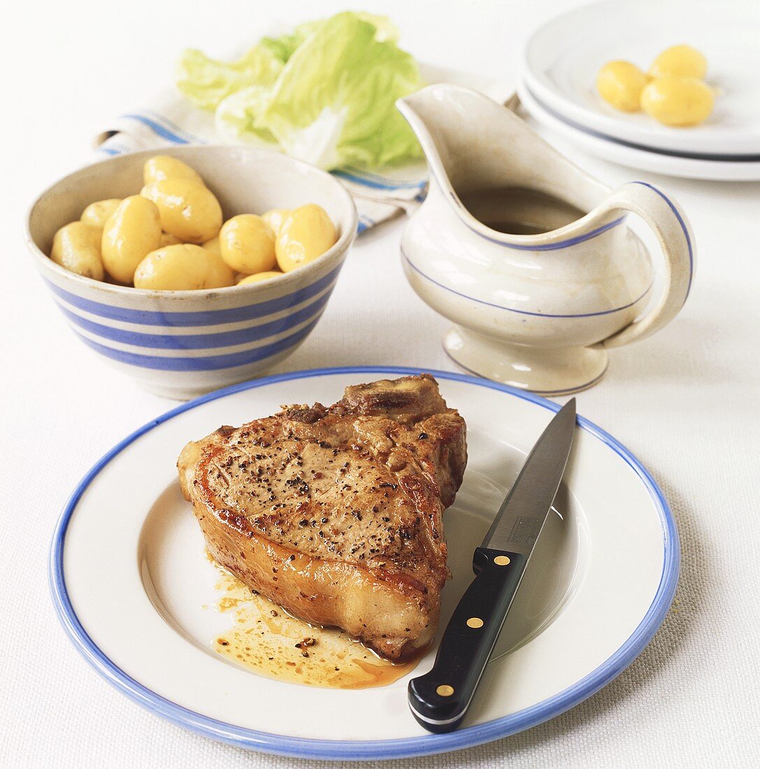 Pork chop with potatoes and lettuce