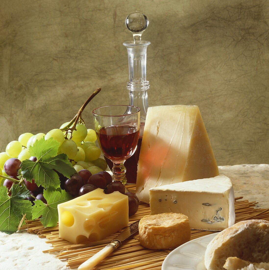 Still life with cheese, wine and grapes
