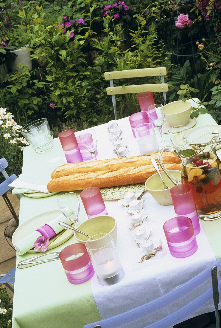 Laid table with baguettes and punch in the open air