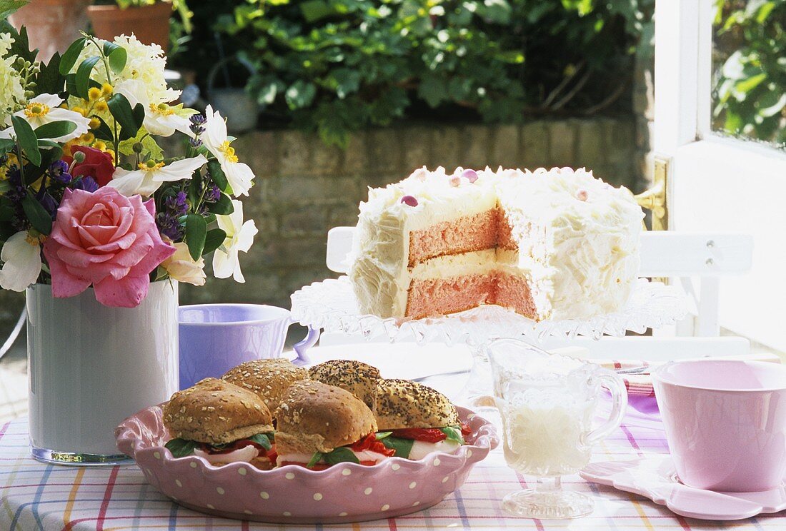 Mozzarella sandwiches & cream cake on table in the open air