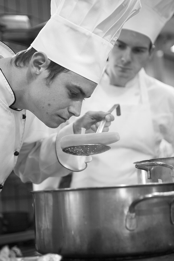 Chef checking a cooked carrot