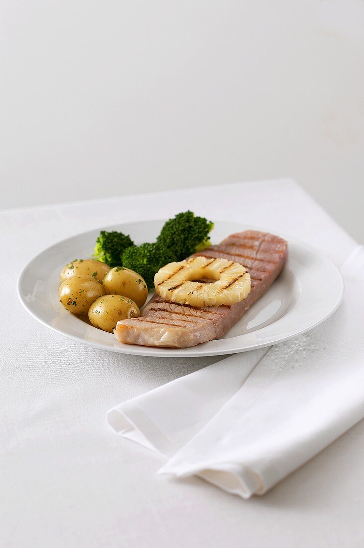Grilled ham with pineapple, potatoes and broccoli