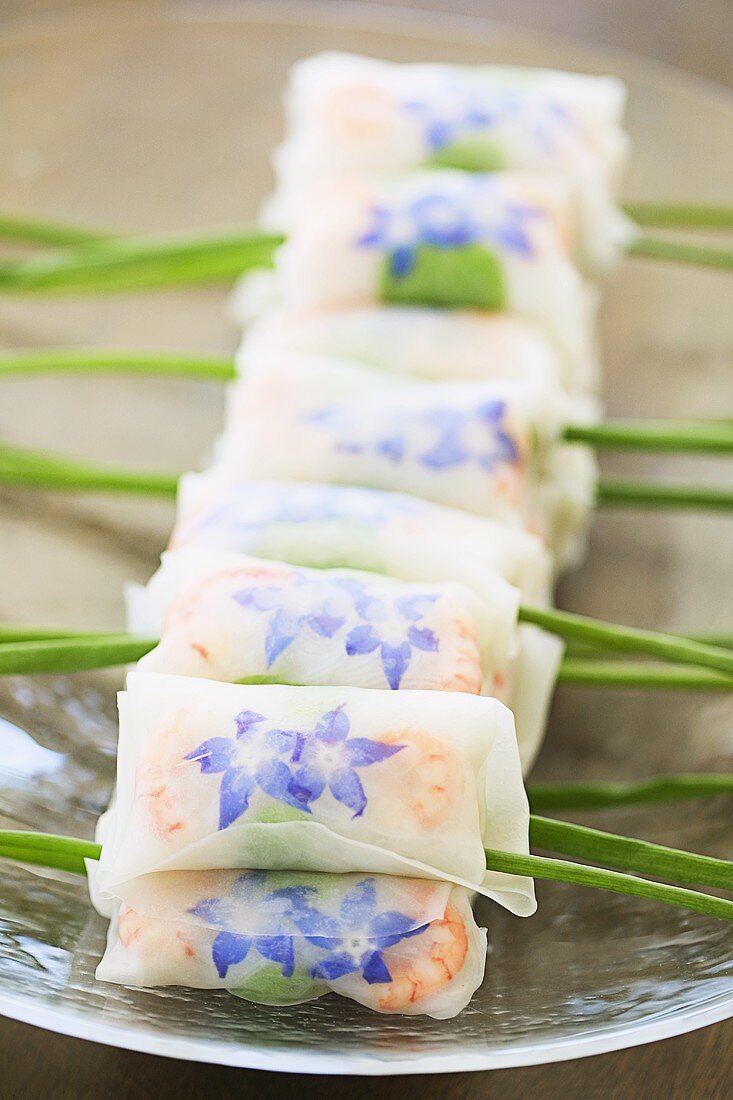 Spring rolls with borage flowers and shrimps