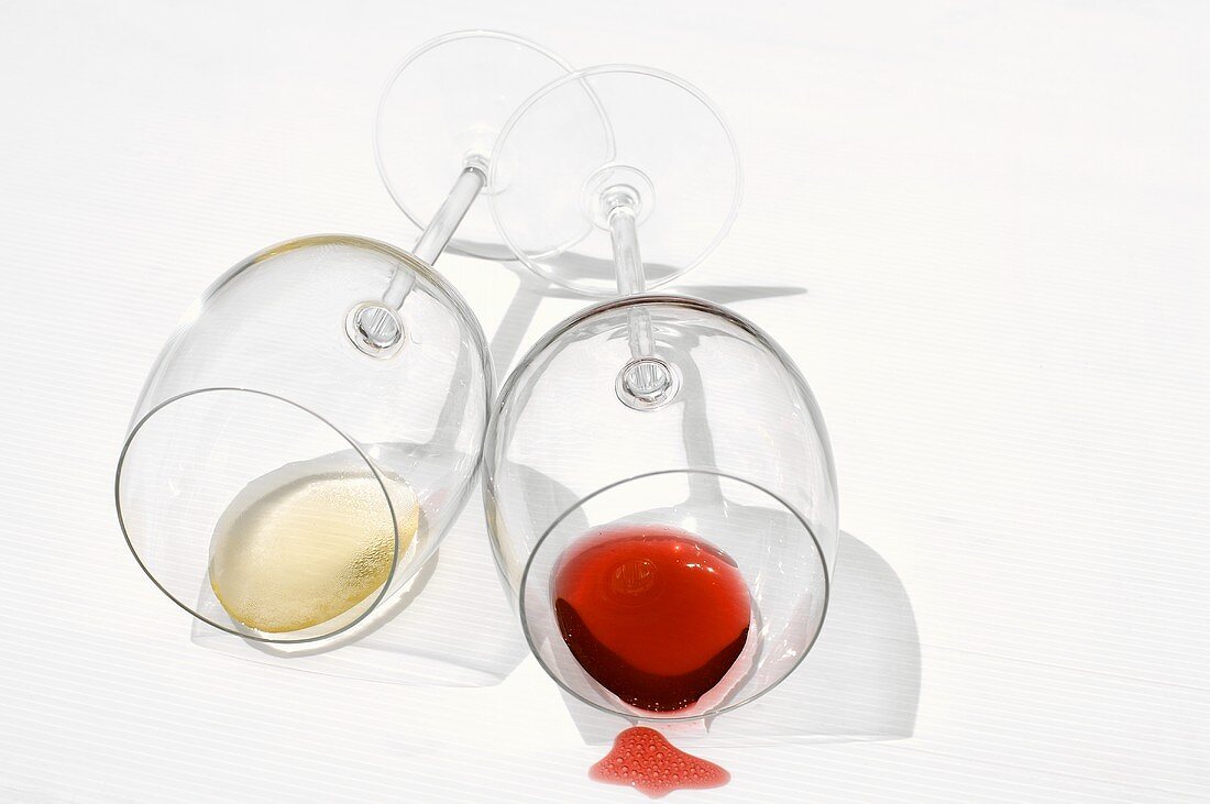 Two wine glasses lying on their sides