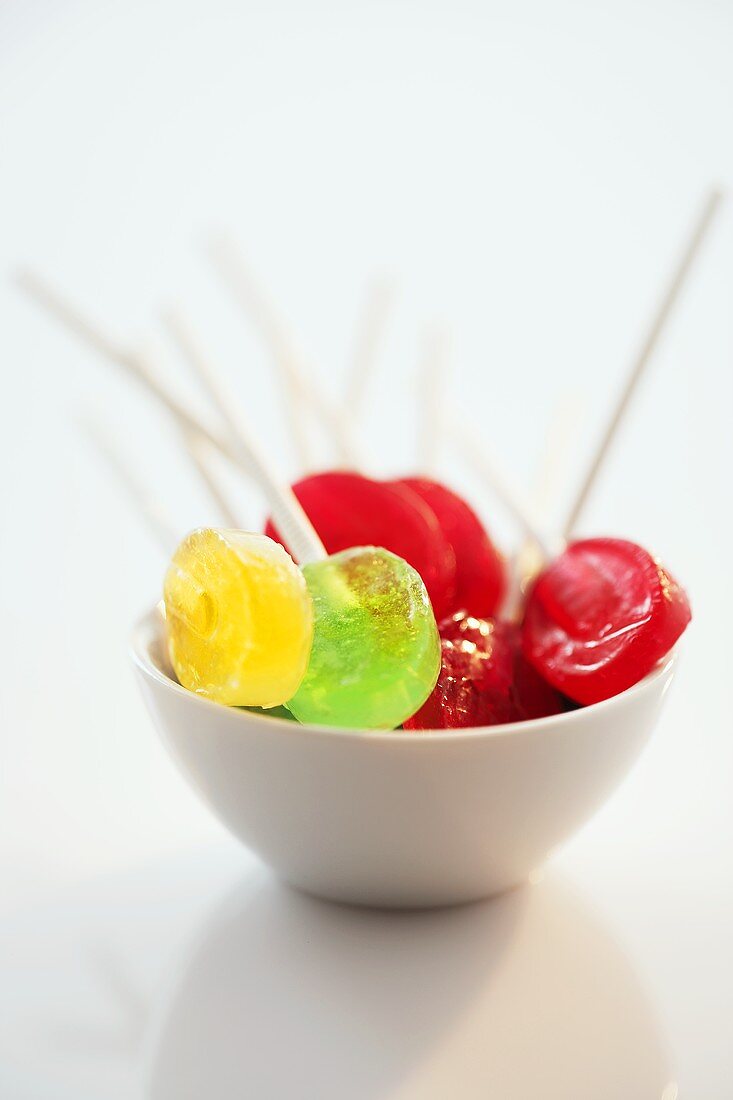 Several lollipops in a small bowl
