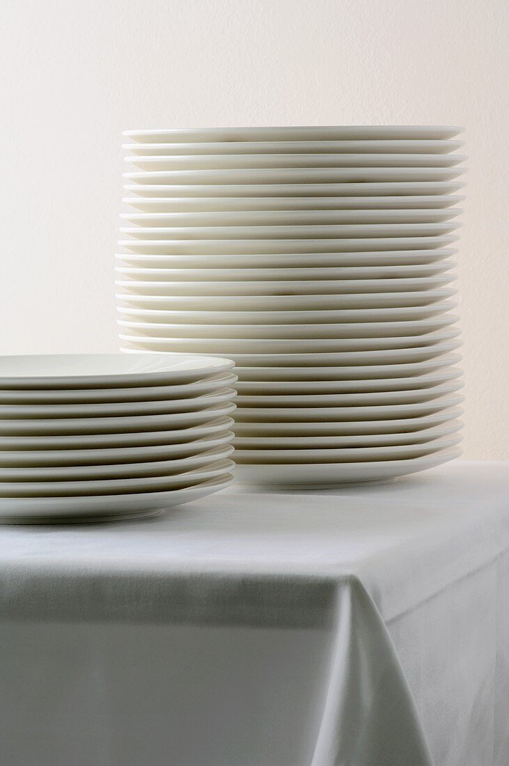 Two piles of plates on a table