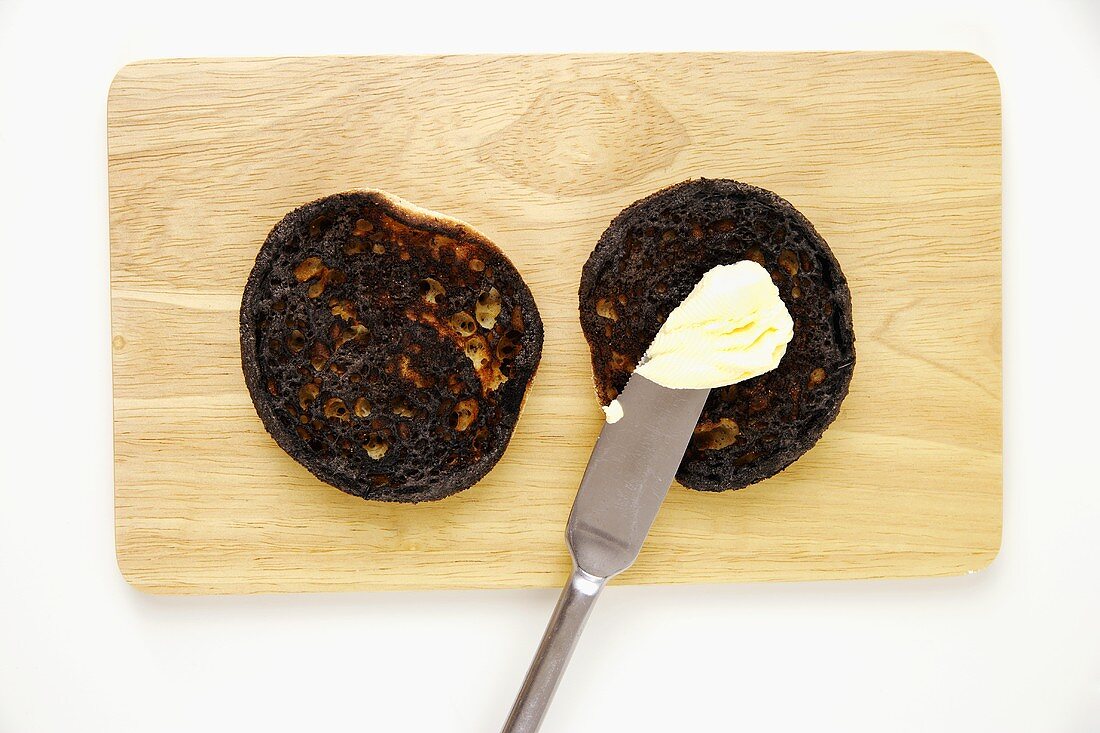 Verbrannter Toast mit Butter und Messer