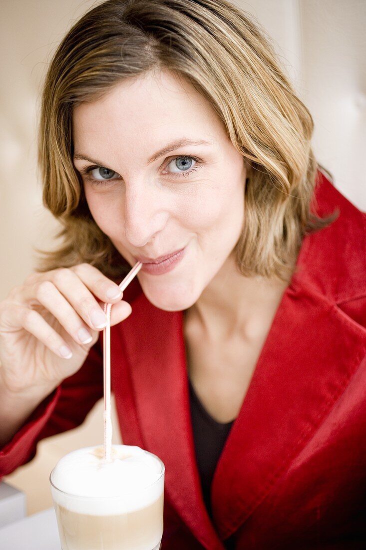 Woman drinking a latte macchiato