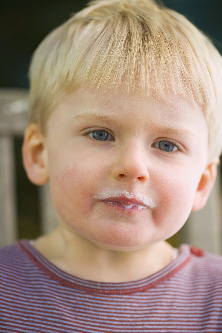 Small boy with milk around his mouth
