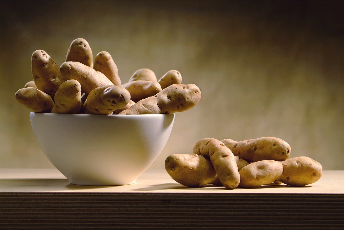 Potatoes in and beside a bowl