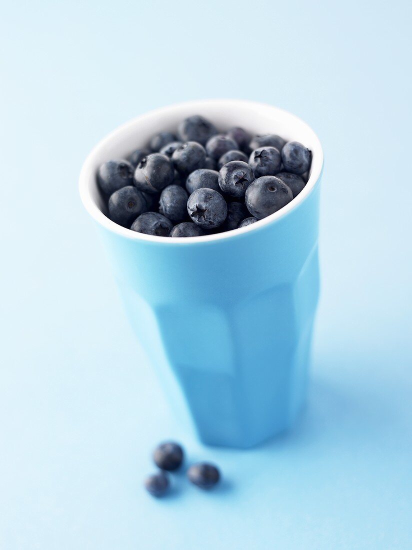Blueberries in a pottery beaker