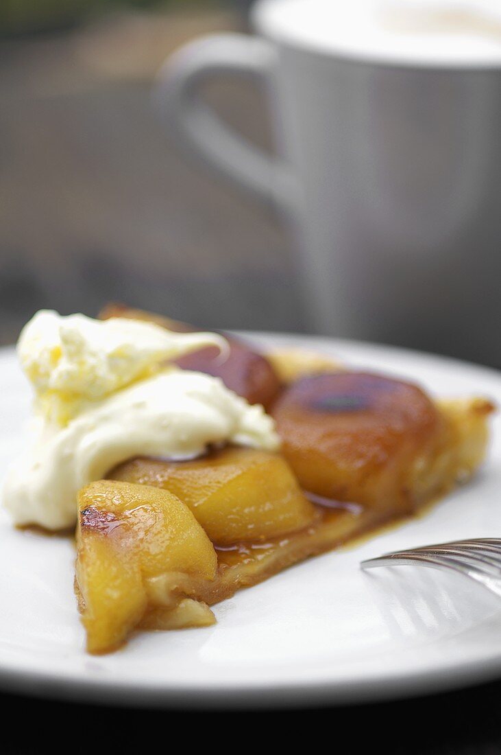 A piece of Tarte Tatin with cream