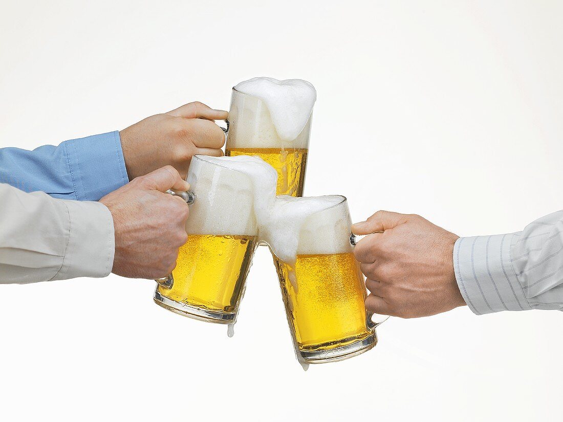Hands clinking beer glasses
