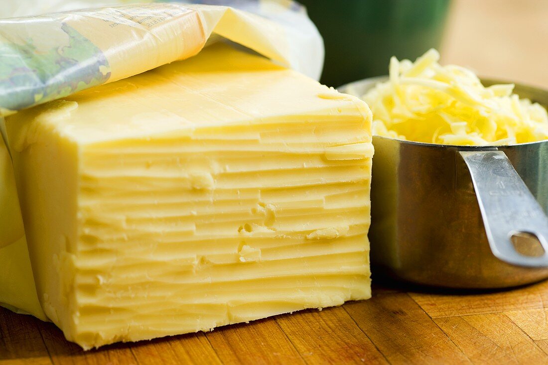 Cheddar cheese, a piece and grated