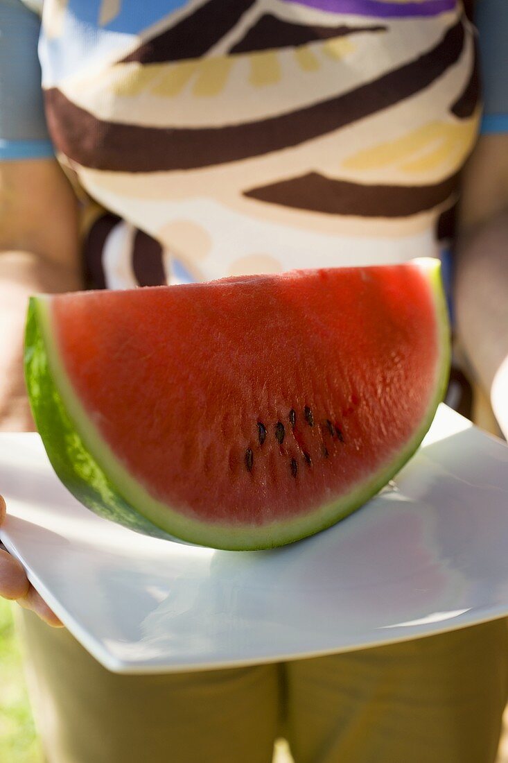 A slice of watermelon on a platter
