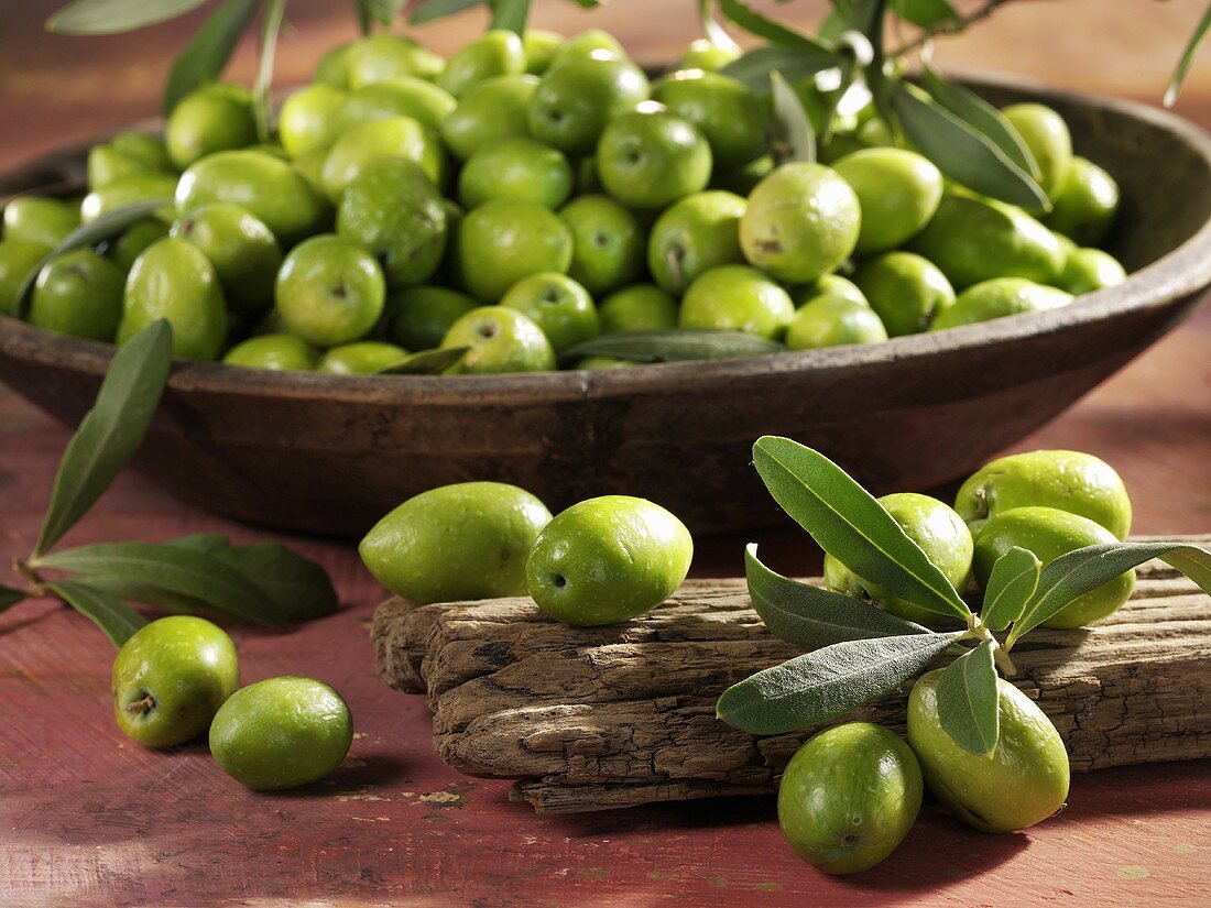 Fresh green olives in a wooden bowl