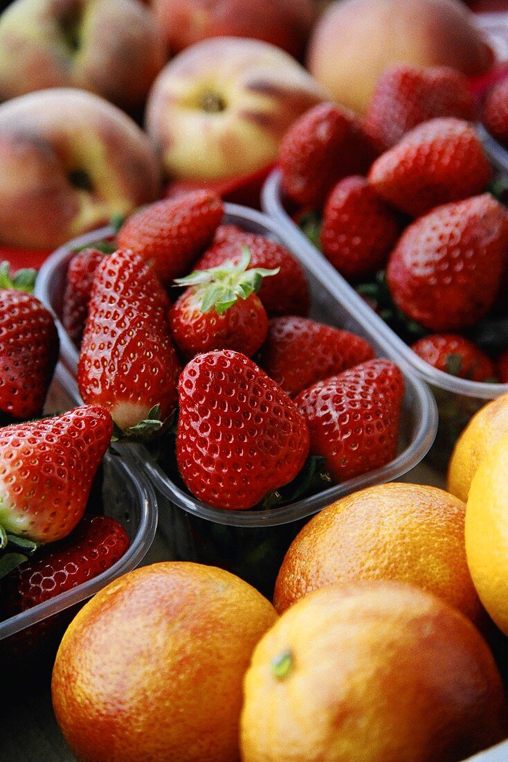 Orangen, Erdbeeren und Pfirsiche auf dem Markt