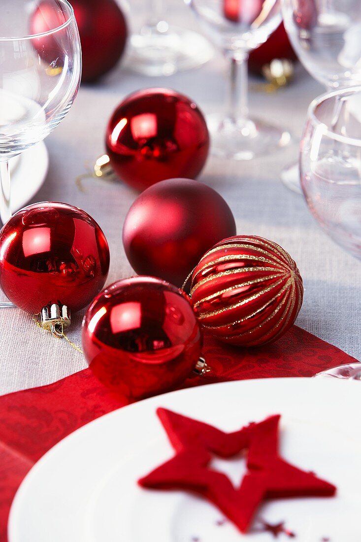 Red Christmas baubles on laid table