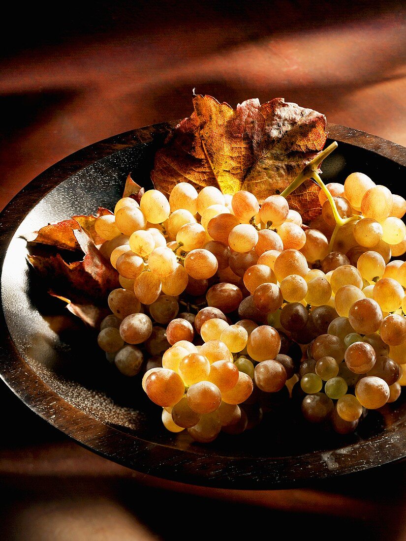 Pink grapes in a wooden bowl