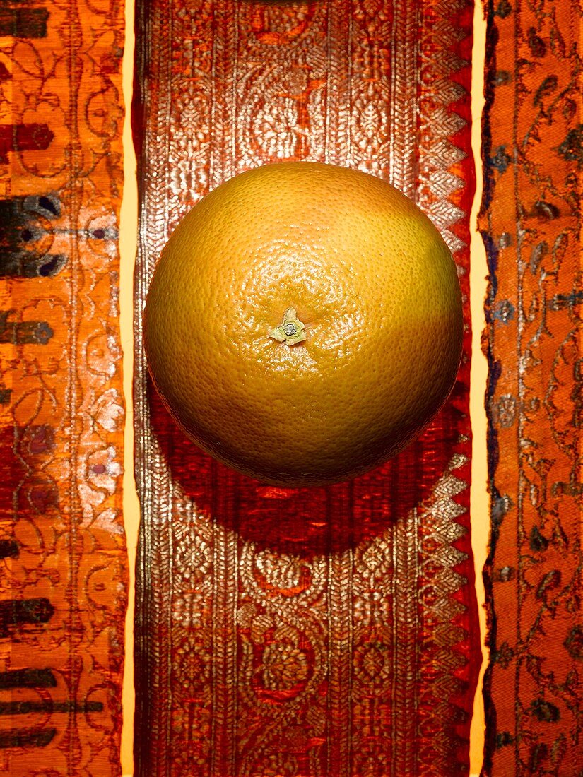 A grapefruit on a Middle Eastern background