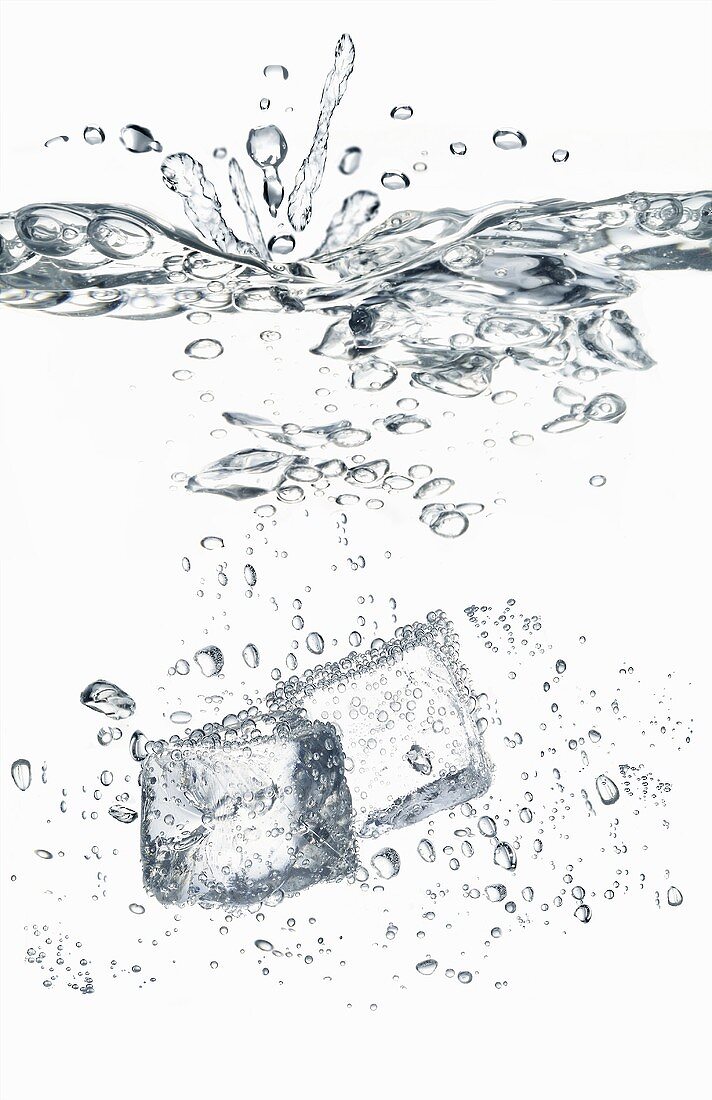 Ice cubes falling into water