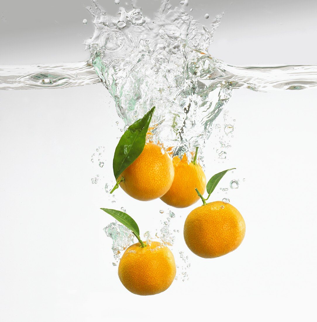 Clementines falling into water