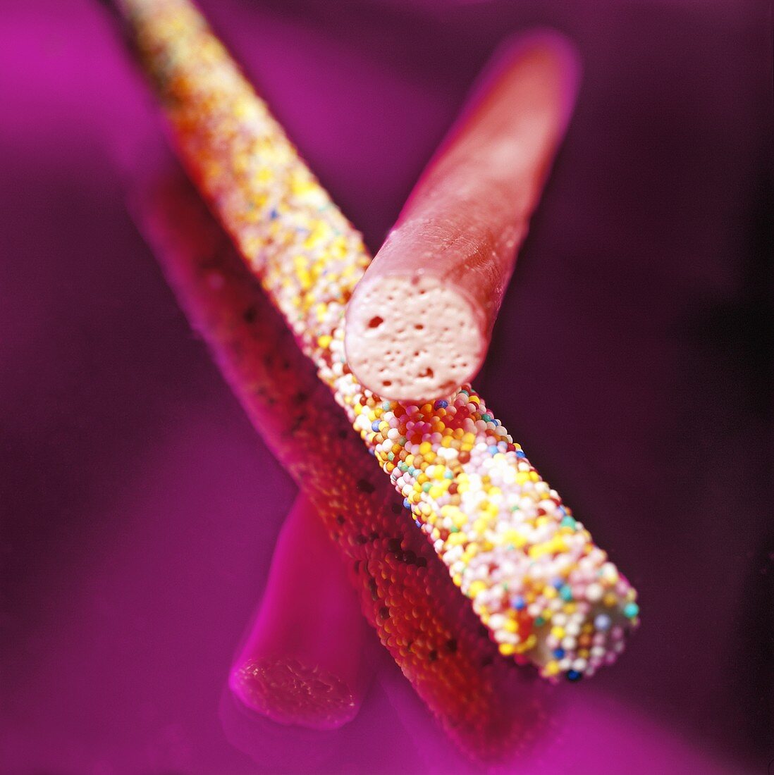 Two sticks of rock (Coloured confectionery sticks, UK)