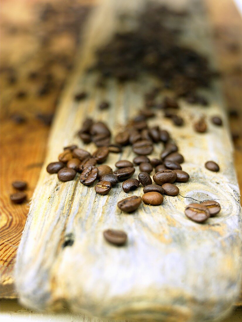 Coffee beans on a plank of wood